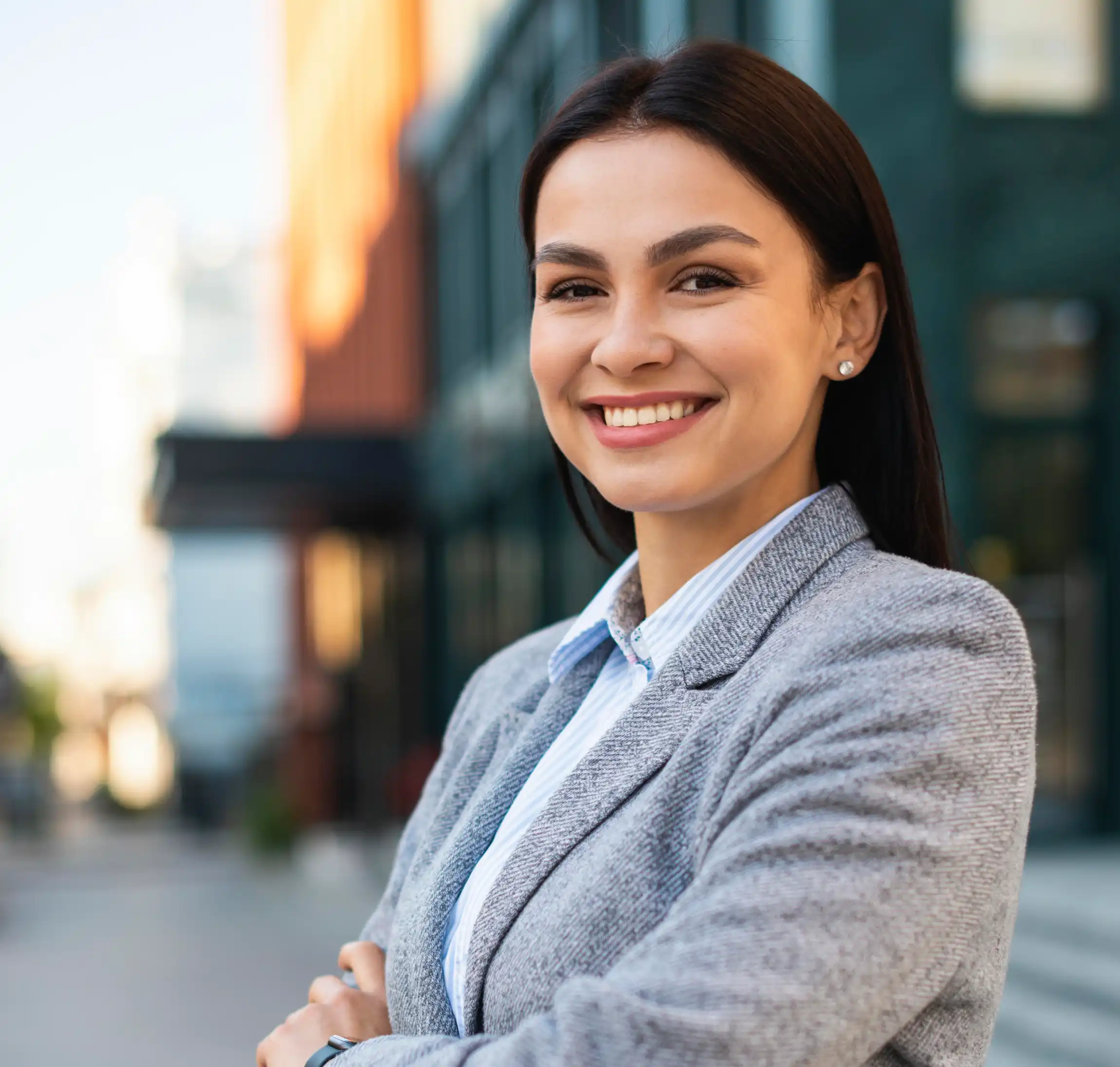 smiling-young-male-professional-standing-with-arms-crossed-while-making-eye-contact-against-isolated-background-3